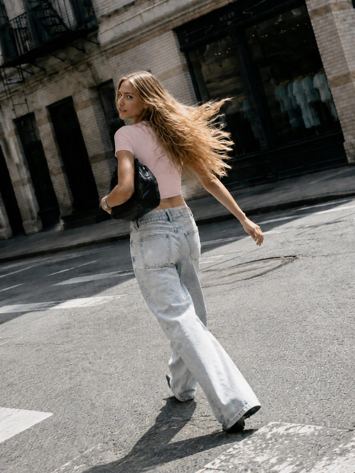 Two Test Kits Baby Tee in Pink on a model, back view showing the fit
